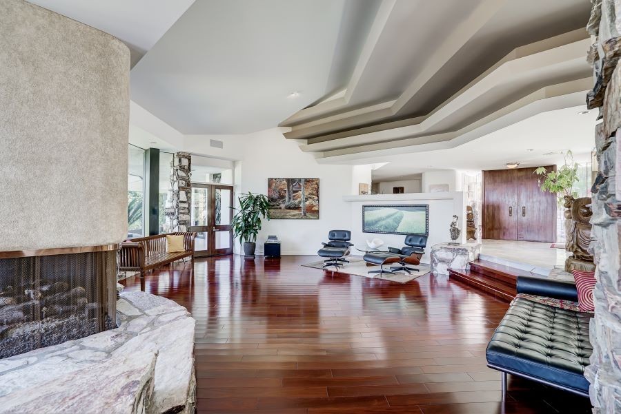 A living room with unique architectural features and in-ceiling speakers.