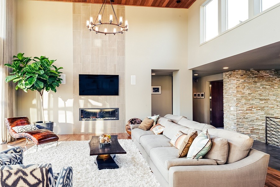 Sunlight streams into a living room with modern, comfortable furnishings and media technology.