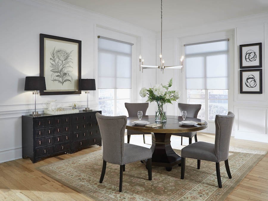 A dining room with custom window treatments.